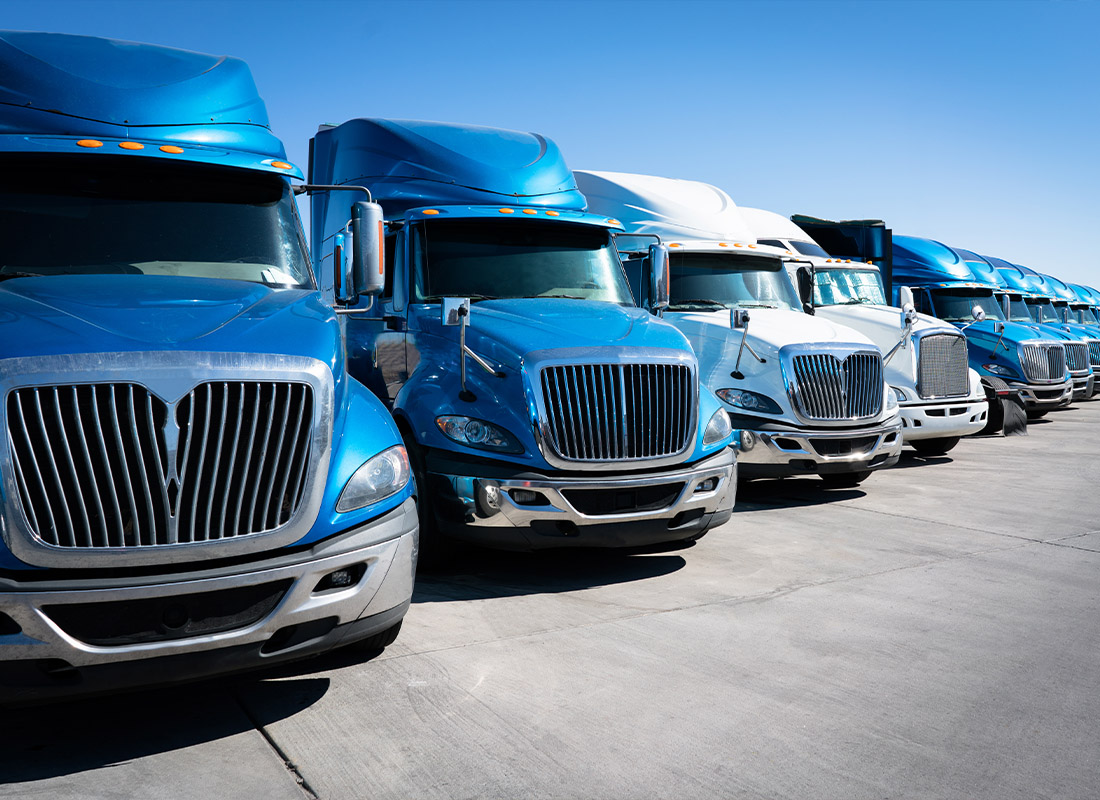Business Insurance - A Fleet of Blue Semis Parked in a Parking Lot